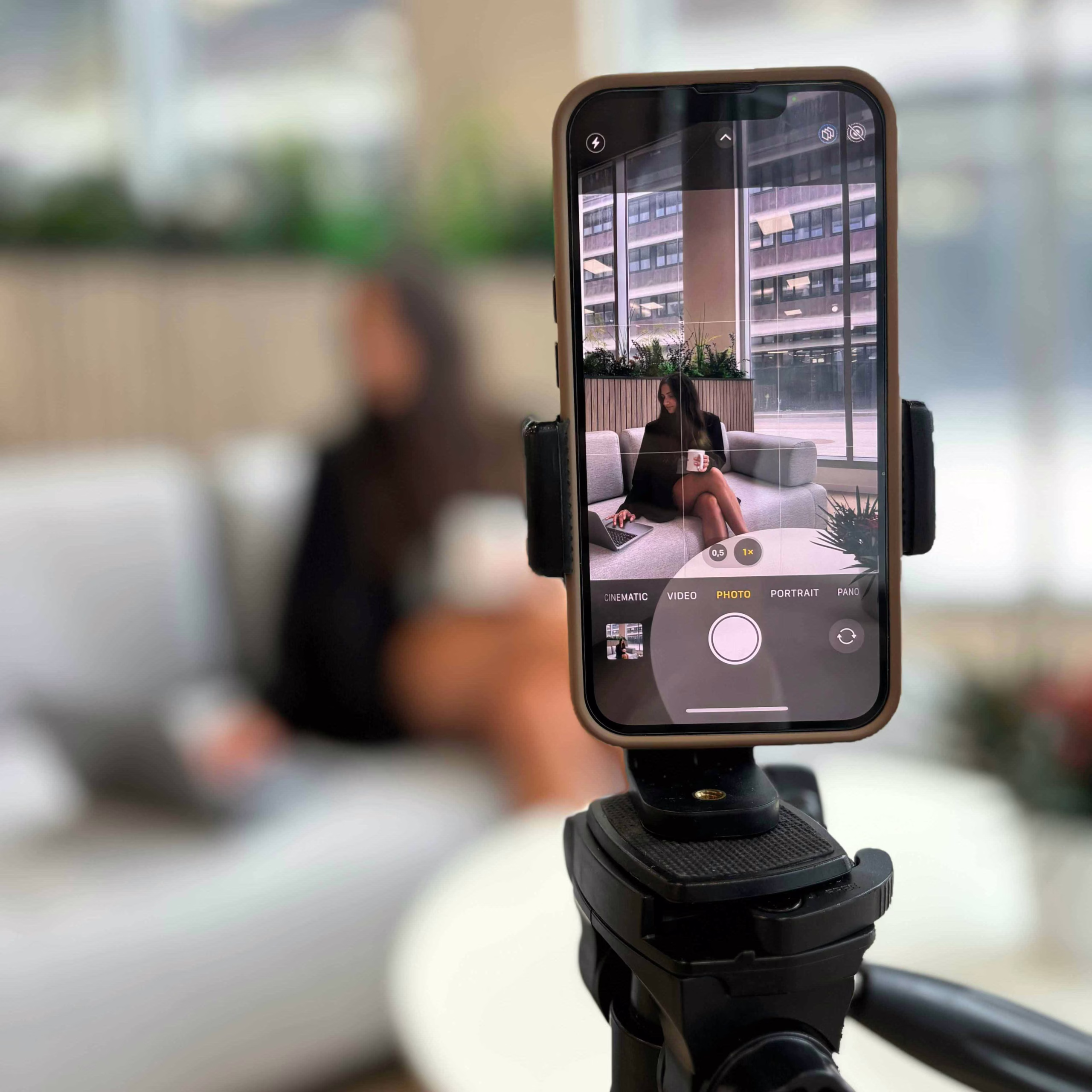A grey laptop with a PC monitor on a wooden desk