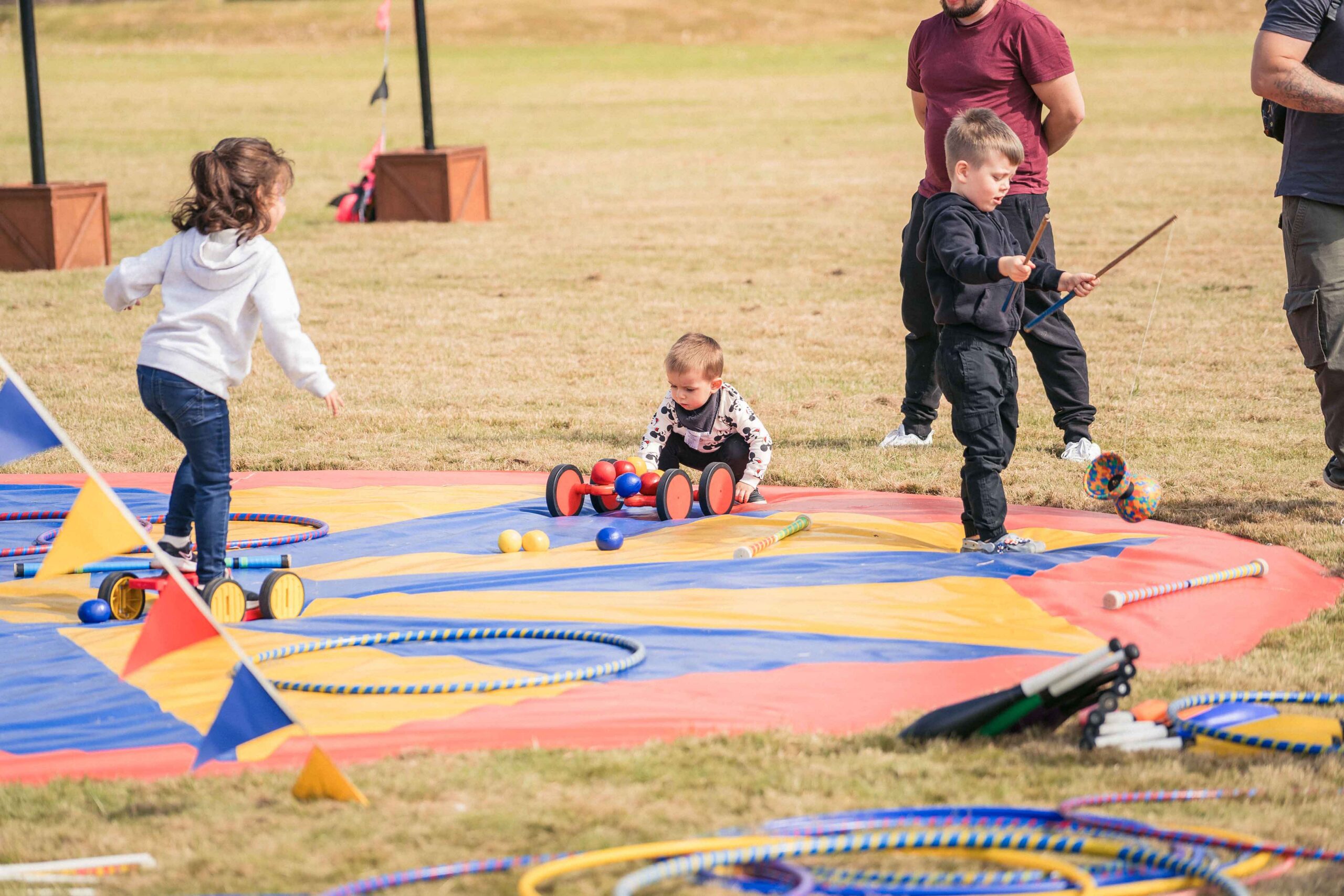 Collins Aerospace Family Fun Day, families enjoying a fairground ride